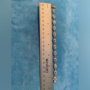 Gold over sterling silver light blue stone bracelet surrounded by CZ